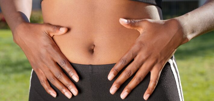 a person touching her belly